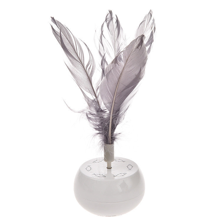 Electric pet tumbler feather cat toy spinning and balancing on indoor floor