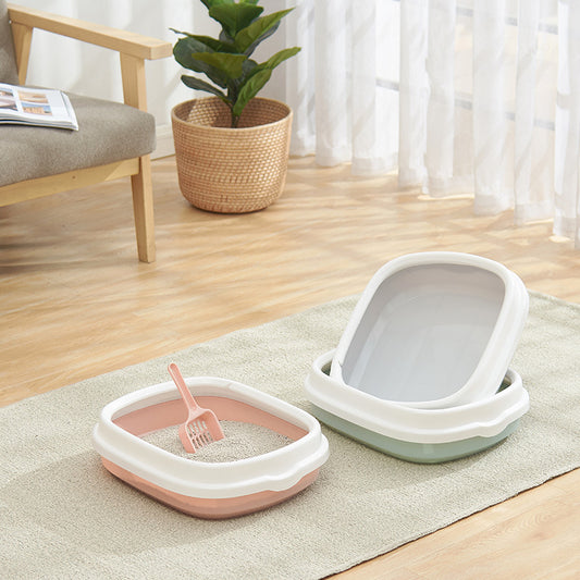 Large detachable anti-splashing cat litter box with high sides on bathroom floor